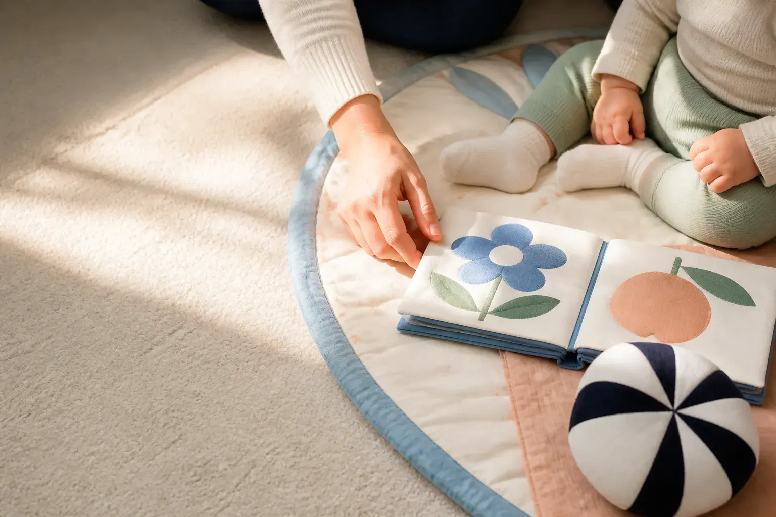 Editorial illustration of a caregiver's hand and a baby's socked feet sharing a quiet play-mat activity